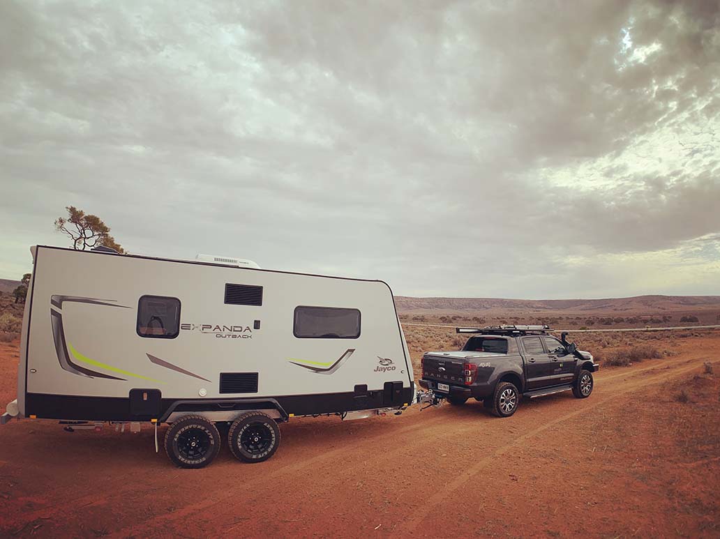 Dean's caravan and four-wheel drive parked on a dirt track.